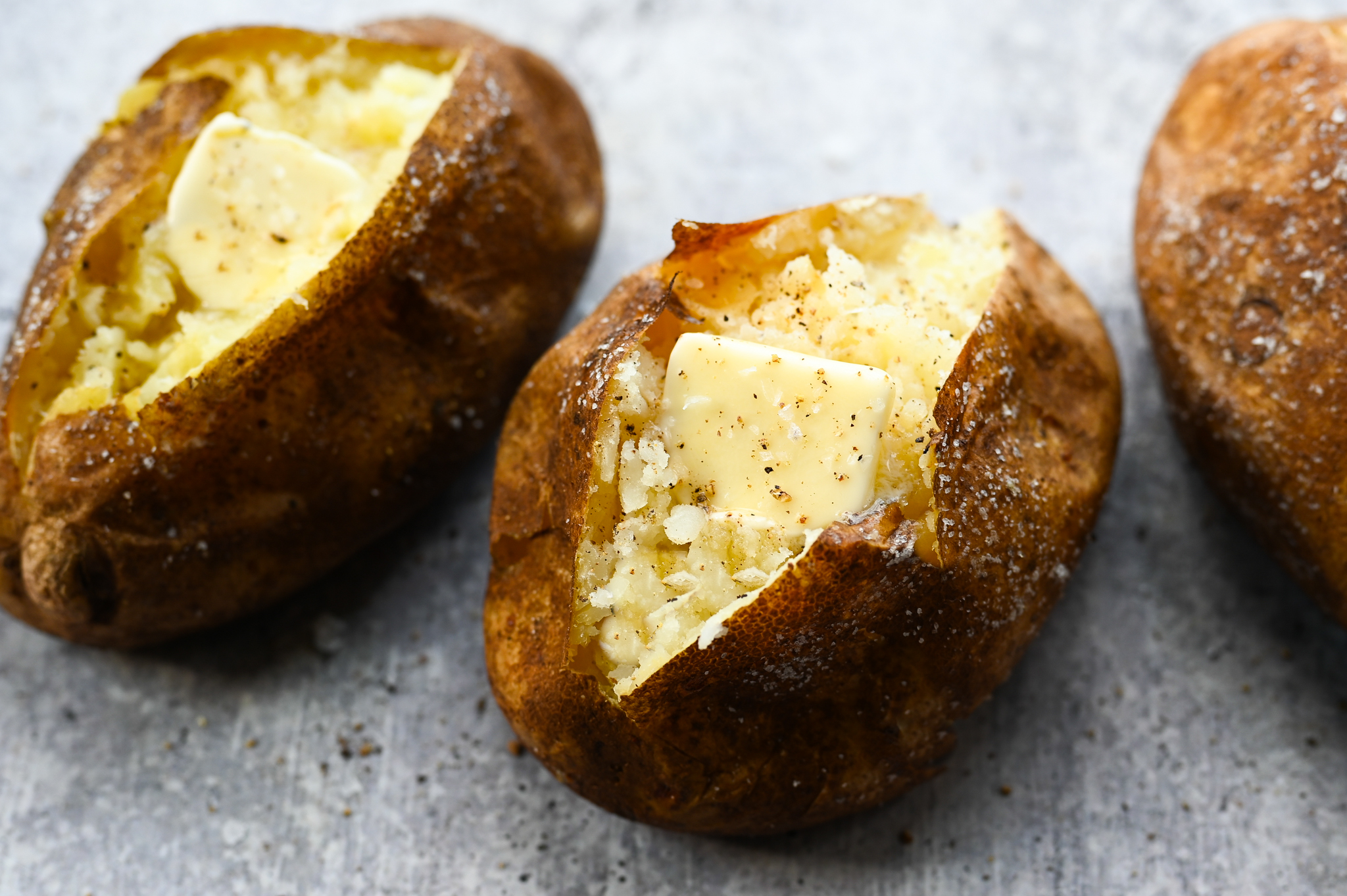 Fresh baked potatoes with butter